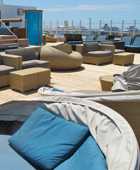 Elegant and modern lounge furniture sun loungers and deck chairs on open outdoor sun deck of luxury...
