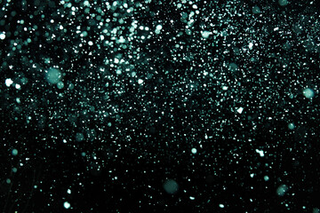 Bright and dark aqua green blue blur bokeh circle on black background for your design