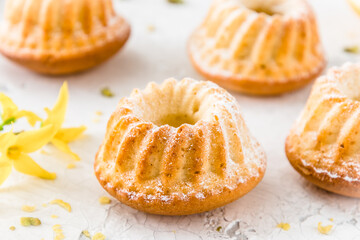 Homemade delicious mini lemon bundt cakes (muffins) on white background