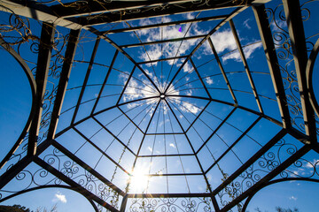 Iron and metal construction in the park on the blue sky background