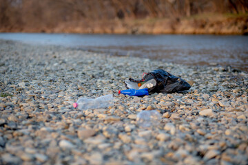 Garbage near the river. Environmental pollution shore