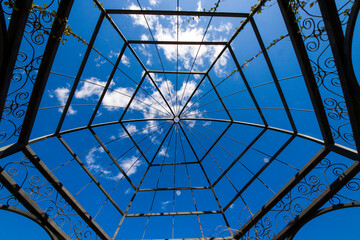 Iron and metal construction in the park on the blue sky background