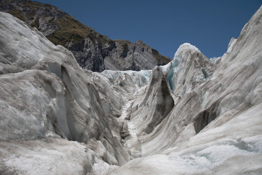 Landscape images from within the Franz Josef glacier showing varying forms of thick ice formations.