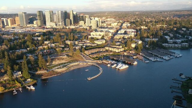 Cinematic aerial sunset drone dolly footage of Meydenbauer Bay Park, Clyde, Eastland, beach park, marinas with Lake Washington Whalers Cove waterfront mansions in Belleview near Seattle, Washington