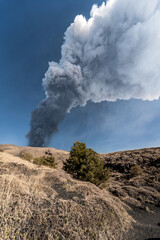 Spectacular eruption of the Etna volcano with column of smoke in the sky