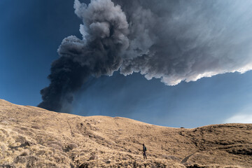 Guy admiring an incredible eruption of the Etna volcano, Sicily