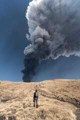 Guy admiring an incredible eruption of the Etna volcano, Sicily