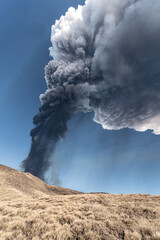 Incredible and frightening eruptive event of the Etna volcano, huge column of smoke in the sky. Catania - Sicily