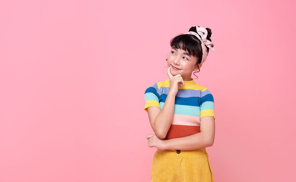 Asian Child Girl Thinking Something Isolated On Pink Background.