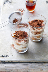 Individual portion of tiramisu dessert in the glass