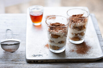 Individual portion of tiramisu dessert in the glass