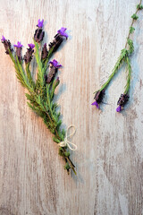 Zenith view. Lavender, natural plant, twigs on light colored wooden table.