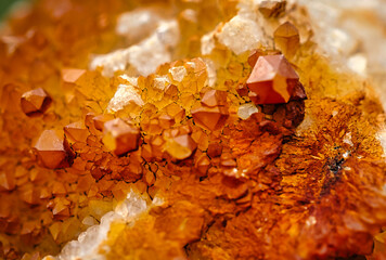 A close up of druzy quartz with small crystals and and iron coating. 