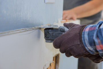 Repair of home on cutting gypsum plasterboard plaster hand sawzall tool