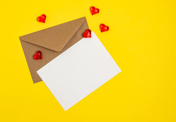 Greeting card mockup, white blank card with paper envelope and hearts on yellow background. Blank love letter, valentine's day, wedding invitation