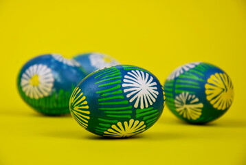 Beautiful hand painted easter eggs stock images. Easter colored eggs isolated on a yellow background stock photo. Traditional easter eggs images