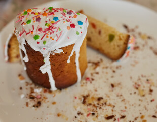 Homemade Easter cake cut into slices on a white plate.