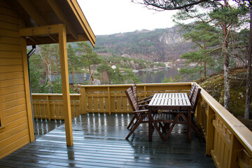 Front porch lake view of beautiful waterfront property with table and chairs - Rogaland Norway