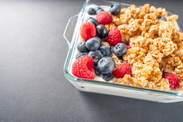 Breakfast of granola and wild berries. Delivered in a glass plate