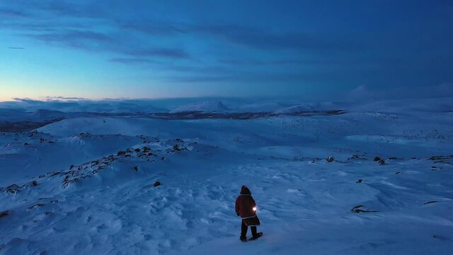 Aerial drone view over Santa standing in the highlands of Lapland, Polar night