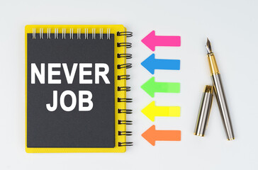 On a white background lies a pen, arrows and a notebook with the inscription - NEVER JOB