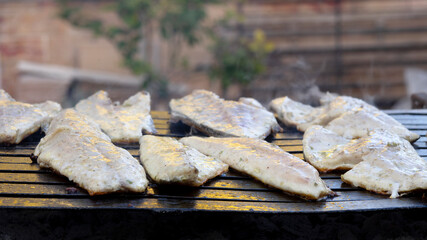 barbecuing fish in the open air