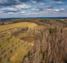 Fototapeta premium Aerial view over forests and meadows of Westerwald, Altenkirchen, Germany