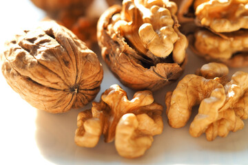 Closeup macro photo of isolated chopped highest quality raw walnut and walnut shell in white background
