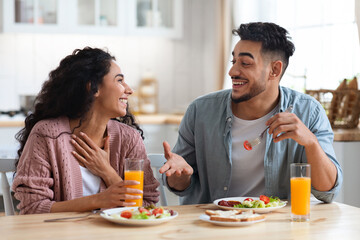 Domestic Life Of Young Couple. Middle Eastern Lovers Having Breakfast In Kitchen