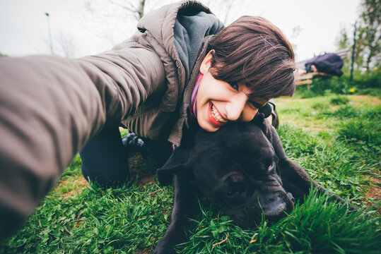Young woman with dog taking selfie