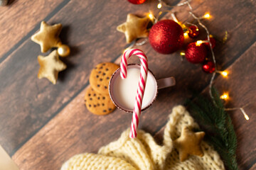 christmas background texture, christmas mood. A glass of milk with gingerbread and candies. Christmas gingerbread. gingerbread with milk. new year lollipop.