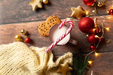 christmas background texture, christmas mood. A glass of milk with gingerbread and candies. Christmas gingerbread. gingerbread with milk. new year lollipop.