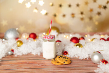 Obraz na płótnie Canvas christmas background, new year mood. A glass of milk with gingerbread. Christmas gingerbread. gingerbread with milk. new year lollipop.