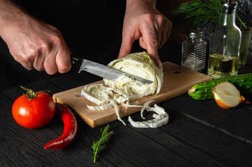 Chef hands cutting fresh chinese cabbage and vegetables for salad. Cooking and concept for restaurant or cafe