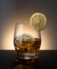Whiskey with ice cubes with lemon
