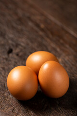 Brown chicken eggs rises on the table.