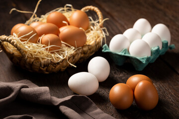 White and brown chicken eggs go up on the table.