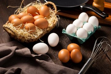 White and brown chicken eggs go up on the table.