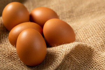 Brown chicken eggs rises on the table.