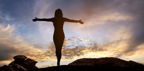 free and happy woman raises her arms at sunset. Have a positive mindset.