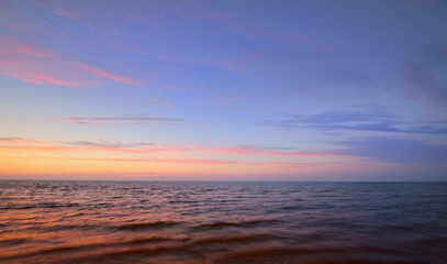 Baltic sea after the rain. Dramatic sunset sky, glowing pink and golden clouds, symmetry...
