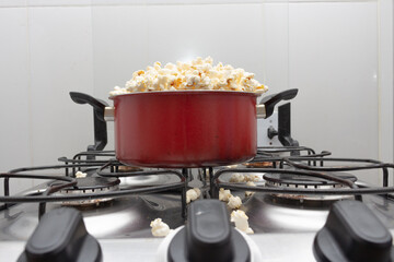 Pan full of popcorn on the stove