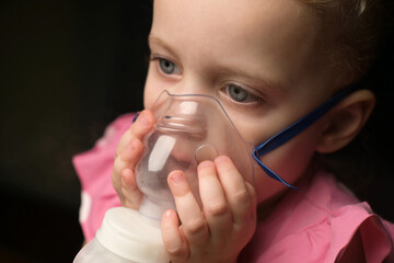 Close-up of a little girl, a child who is being treated with inhalation
