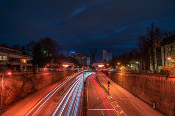 Munich, Germany - fast driving cars next to the central Effnerplatz in the bavarian capital at night with busy traffic as long exposure image, wonderful background.