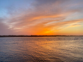 The mouth of the Cavado River at sunset in Esposende, Portugal.