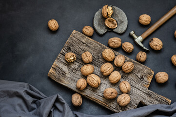 Ripe and raw whole big walnut kernel with shell on rustic backdrop. healthy nut food for brain