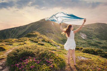 Woman feel freedom and enjoying the mountaine nature at sunset