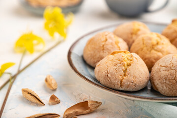 Almond cookies and a cup of coffee on a white concrete background Side view, selective focus.