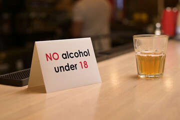 close-up of a sign on the restriction of the sale of alcohol due to the age of eighteen years