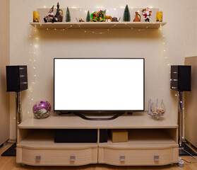 TV in the background of speakers and Christmas accessories, mockup